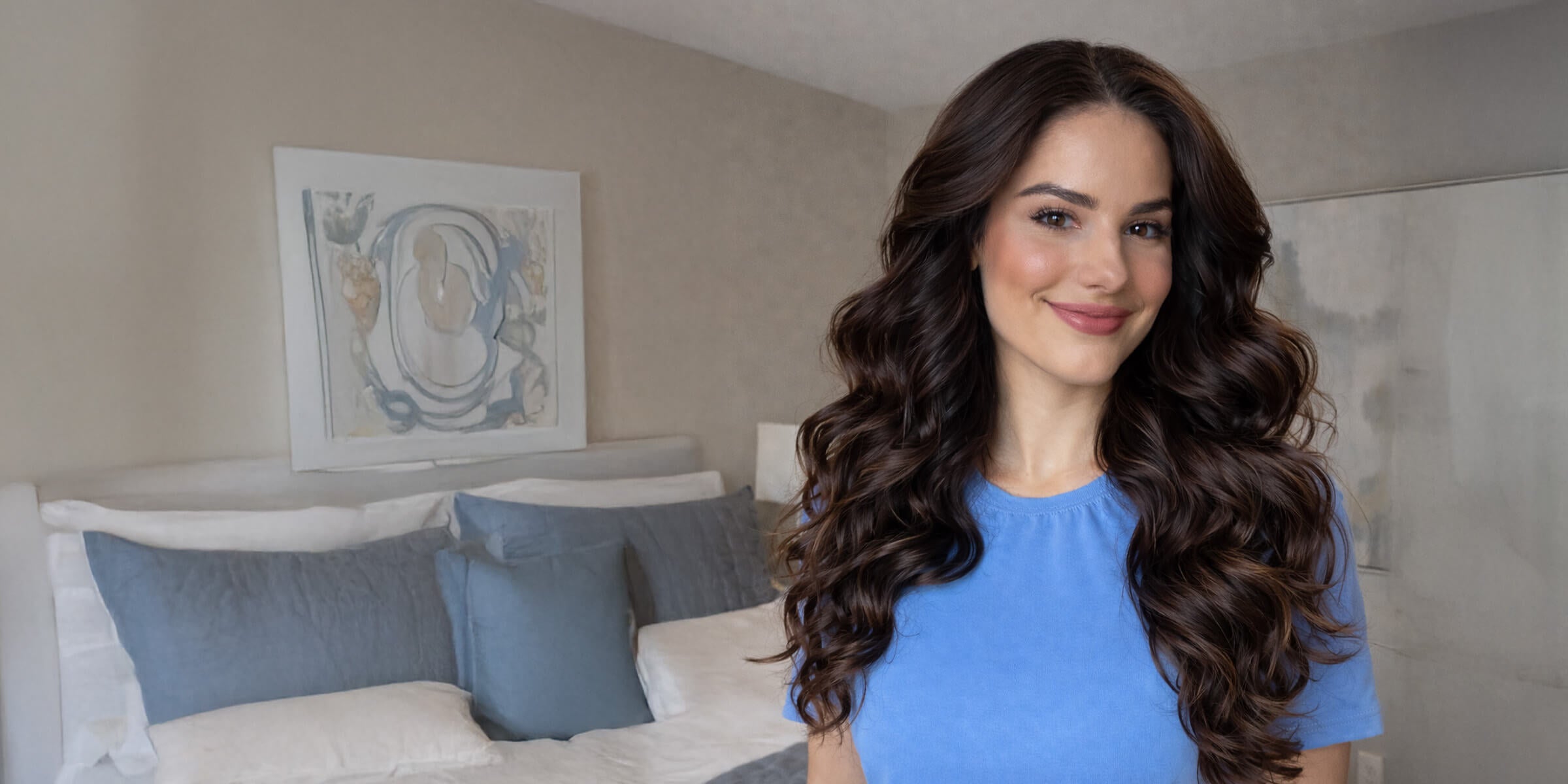 Woman with long, voluminous curls styled using an automatic curling iron